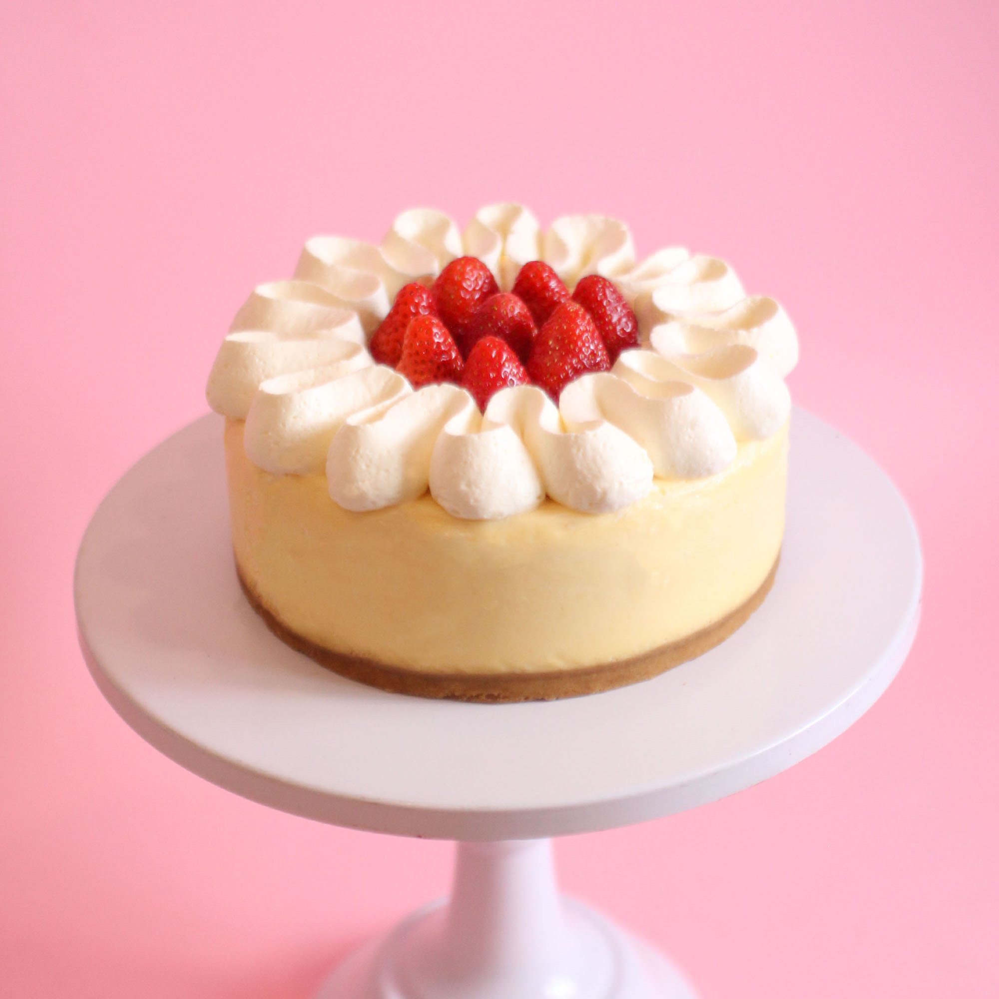Cheesecake Ngon’s strawberry cheesecake on a pink cake stand